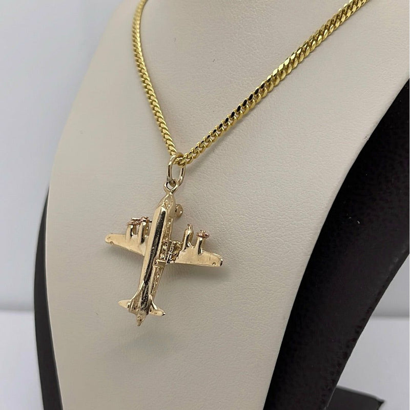 gold necklace with airplane pendant